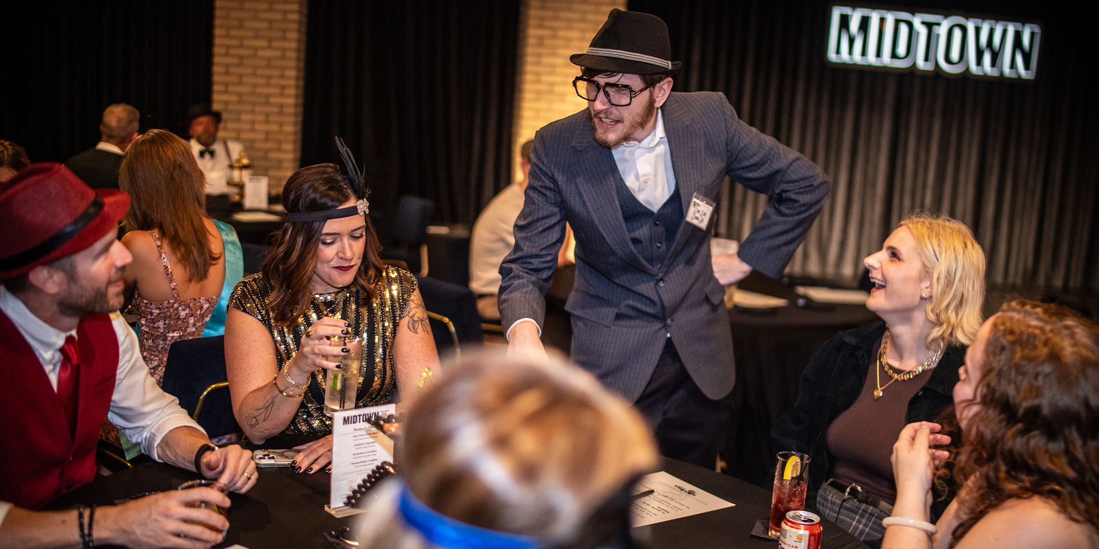 Guests at a Murder Mystery Company public dinner show in Orlando